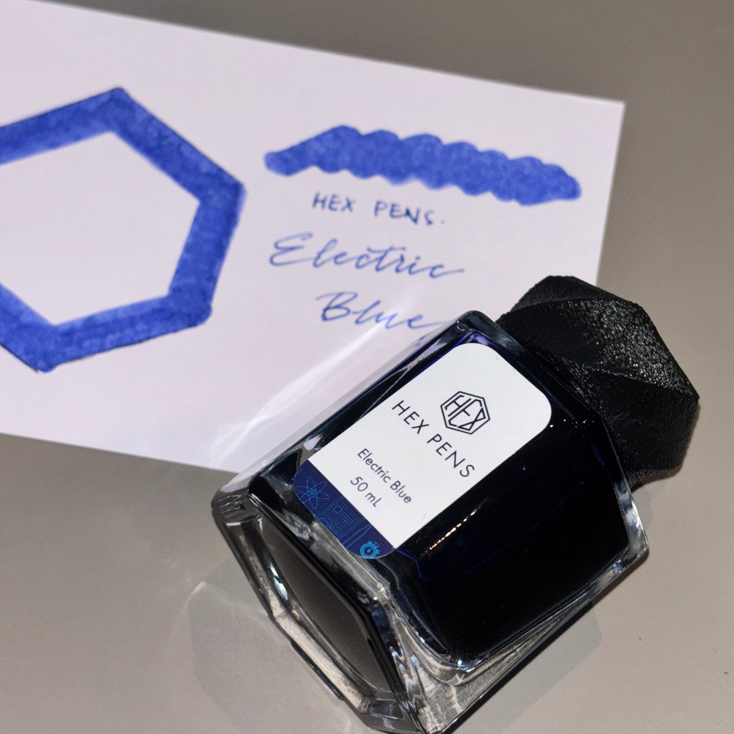 Hex Pens Electric Blue Ink Bottle with Ink Swatch in the Background