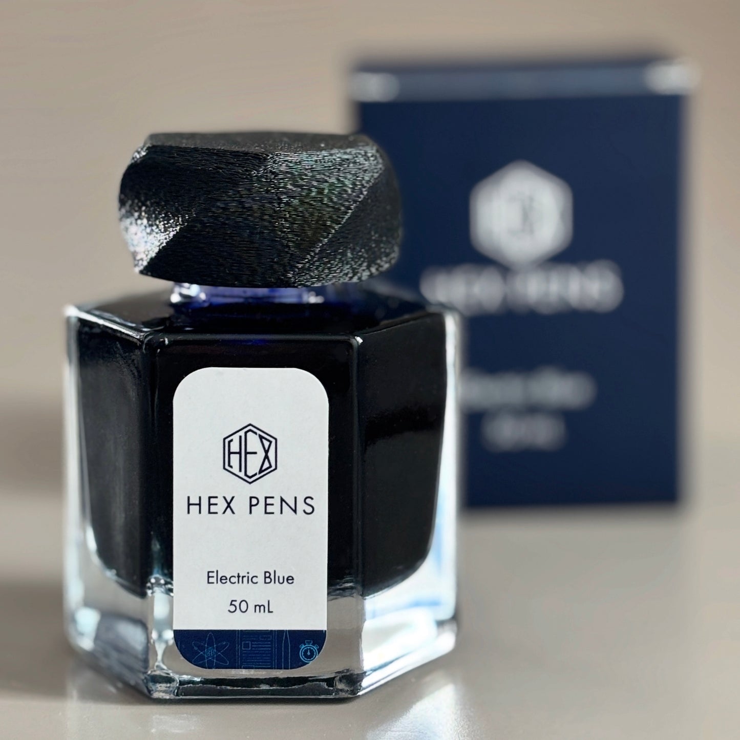 Hex Pens Electric Blue Ink Bottle with Box in the Background