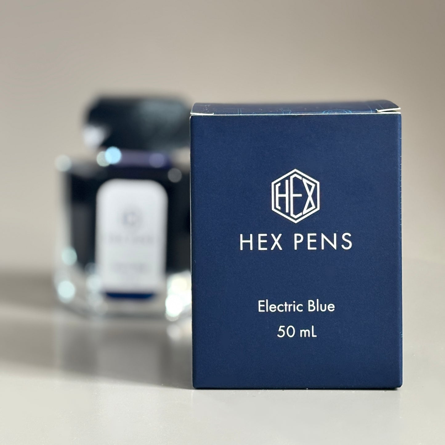 Hex Pens Electric Blue Ink Box with Bottle in the Background